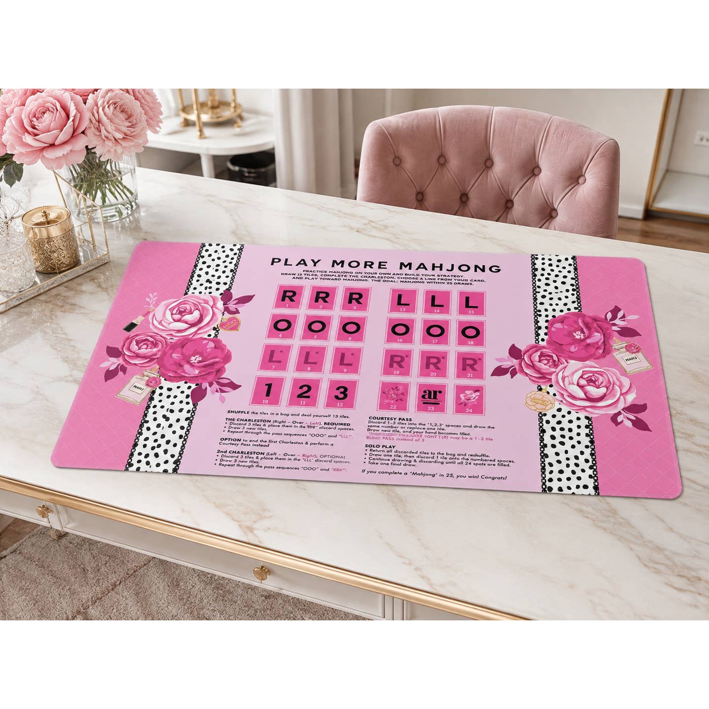 Eau de Mahj solo play mahjong mat styled on a marble table with pink roses