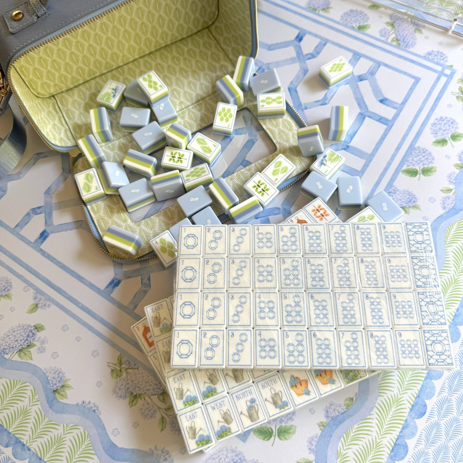 House of Hydrangea mahjong tiles spilling from the blue keepsake storage case with game card