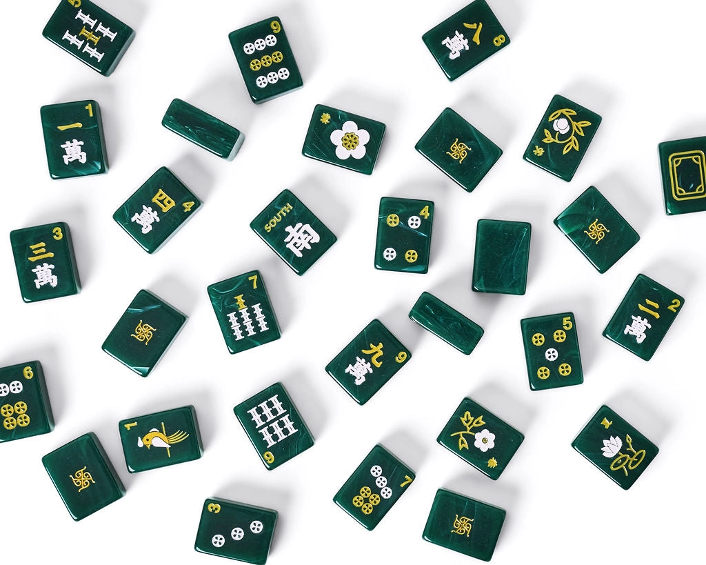 Emerald Tradewind mahjong tiles scattered — craks, bams, flowers, and winds