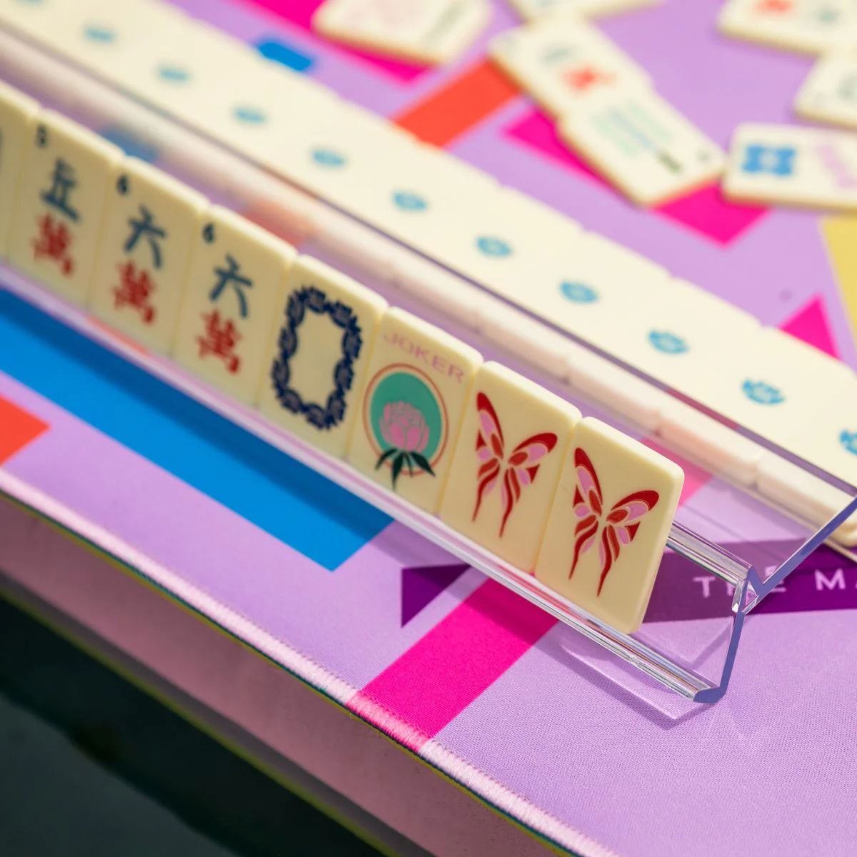 Butter Yellow travel mahjong tiles on a clear rack showing craks, soap, joker and flower tiles