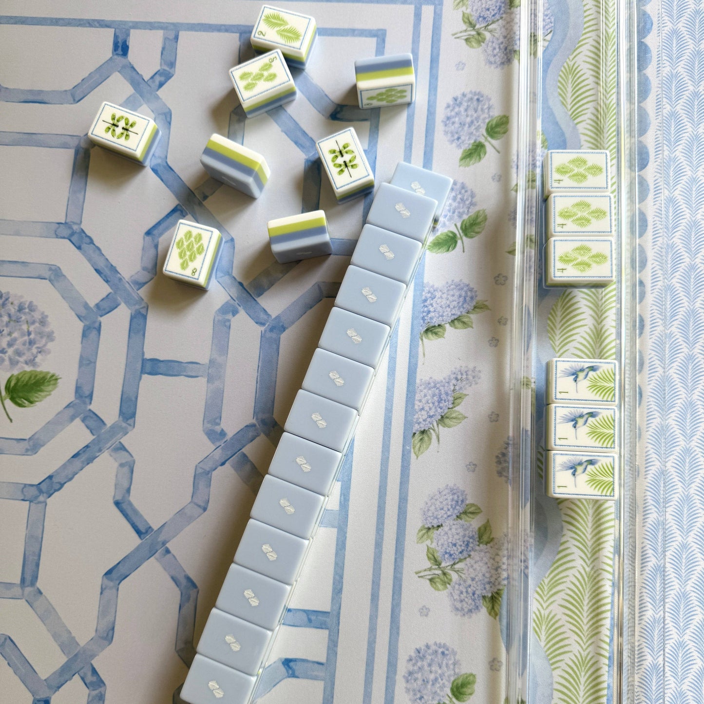Overhead view of House of Hydrangea mahjong tiles and racks on the hydrangea garden mat