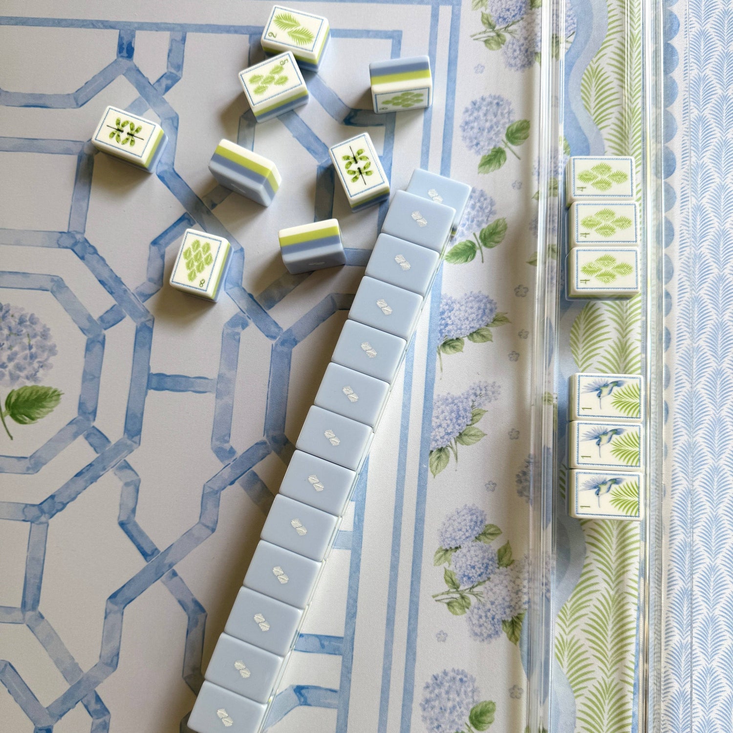 Overhead view of House of Hydrangea mahjong tiles and racks on the hydrangea garden mat