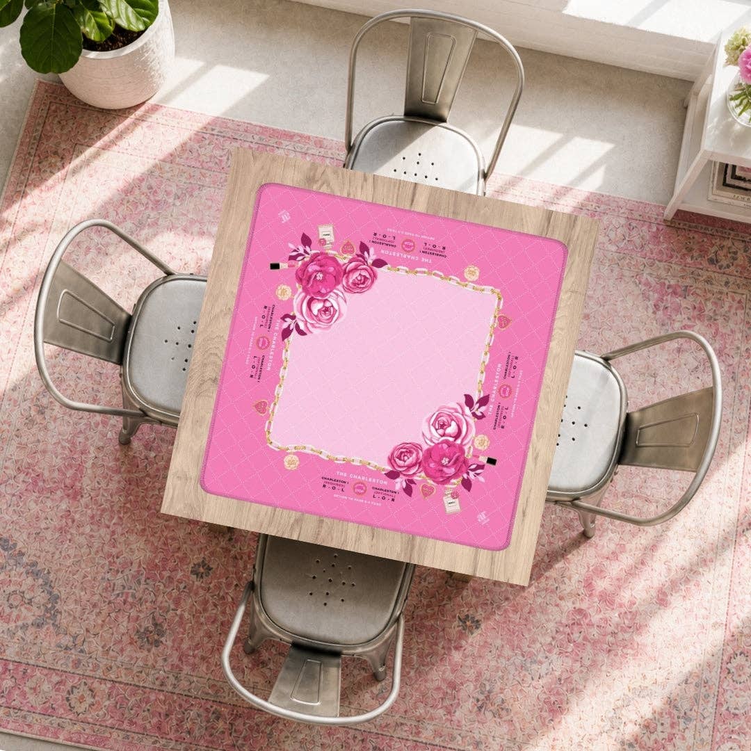 Charming Blooms mahjong mat styled on a sunlit dining table with a pink floral rug