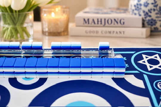 Evil Eye mahjong mat on a styled table with mahjong books and decor