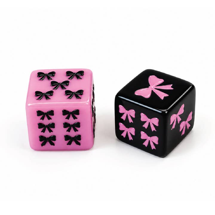 Eau De Mahj mahjong dice — pink die with black bow pips and black die with pink bow pips