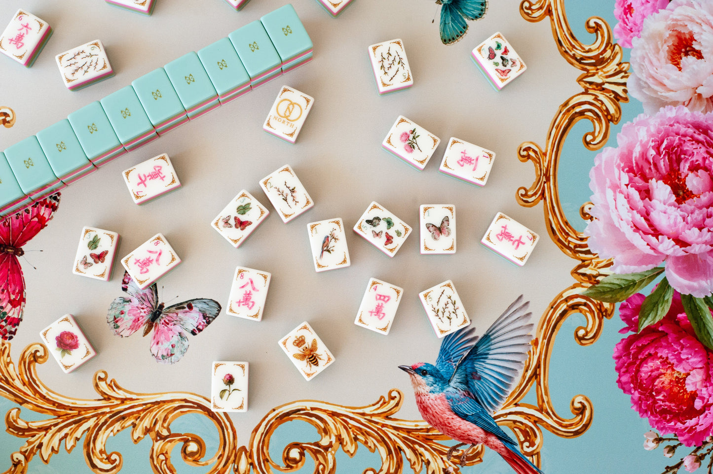 Mahj in Bloom mahjong tile set flat lay — butterfly dots, bird one-bam, and peony flowers