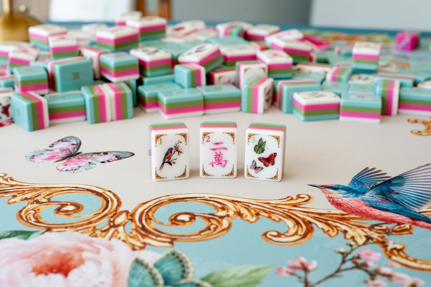 Mahj in Bloom mahjong tiles close-up — bird one-bam, pink crak, and butterfly dot